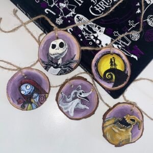 Image of 5 wooden Nightmare before Christmas themed decorations set against a book